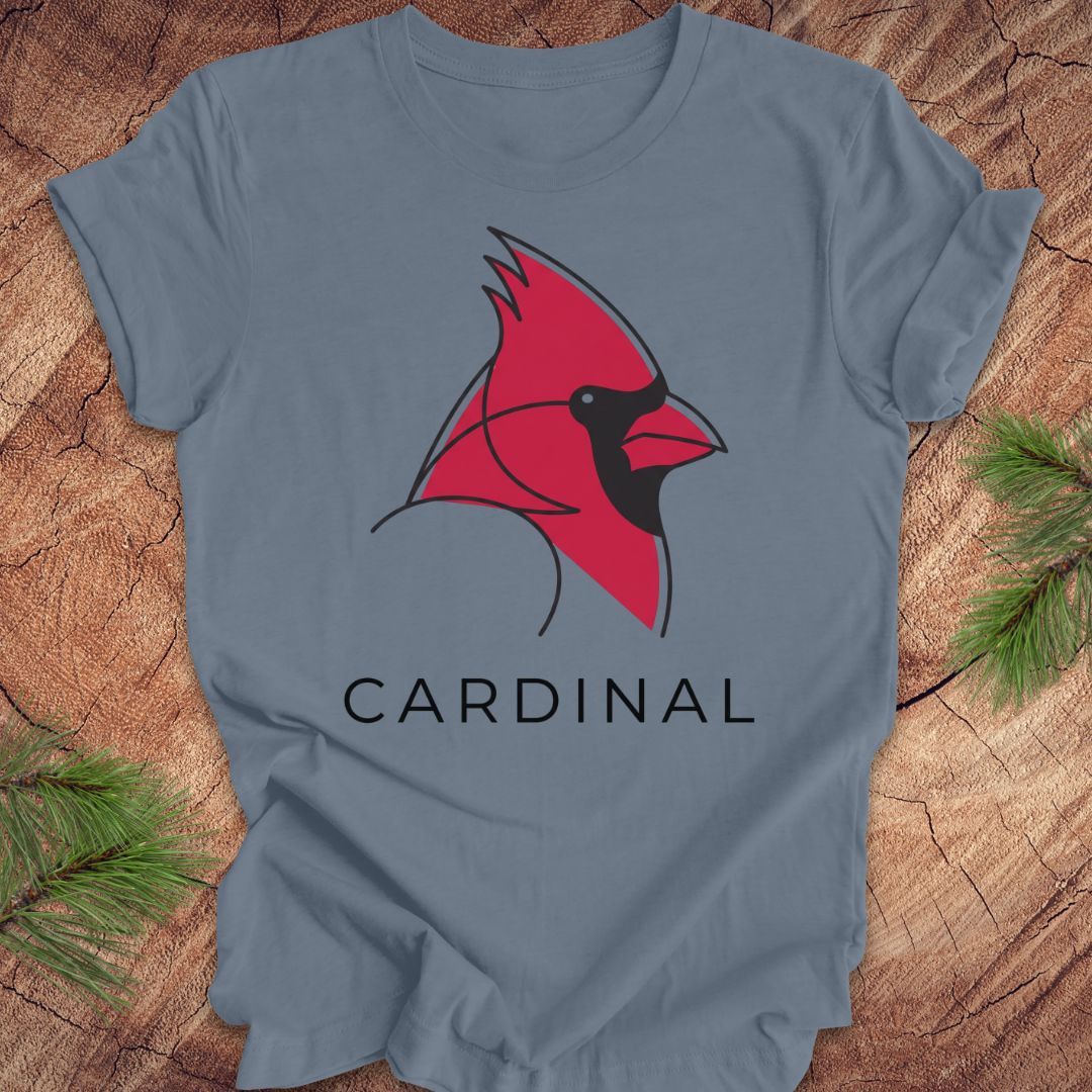 Blue t-shirt with a cardinal and text on a wood background.
