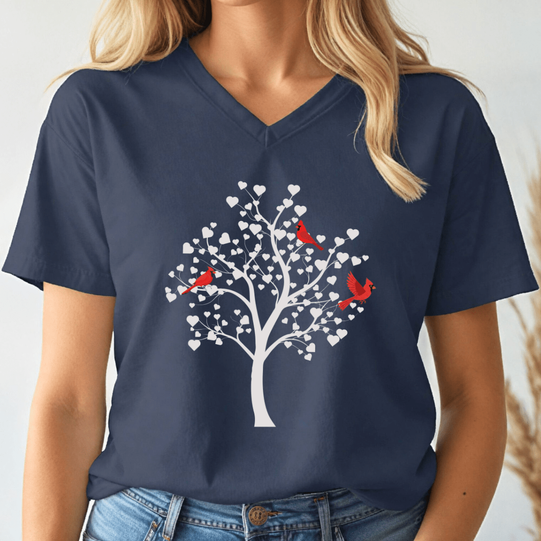 Navy blue v-neck t-shirt with a white tree and cardinals design worn by a person.