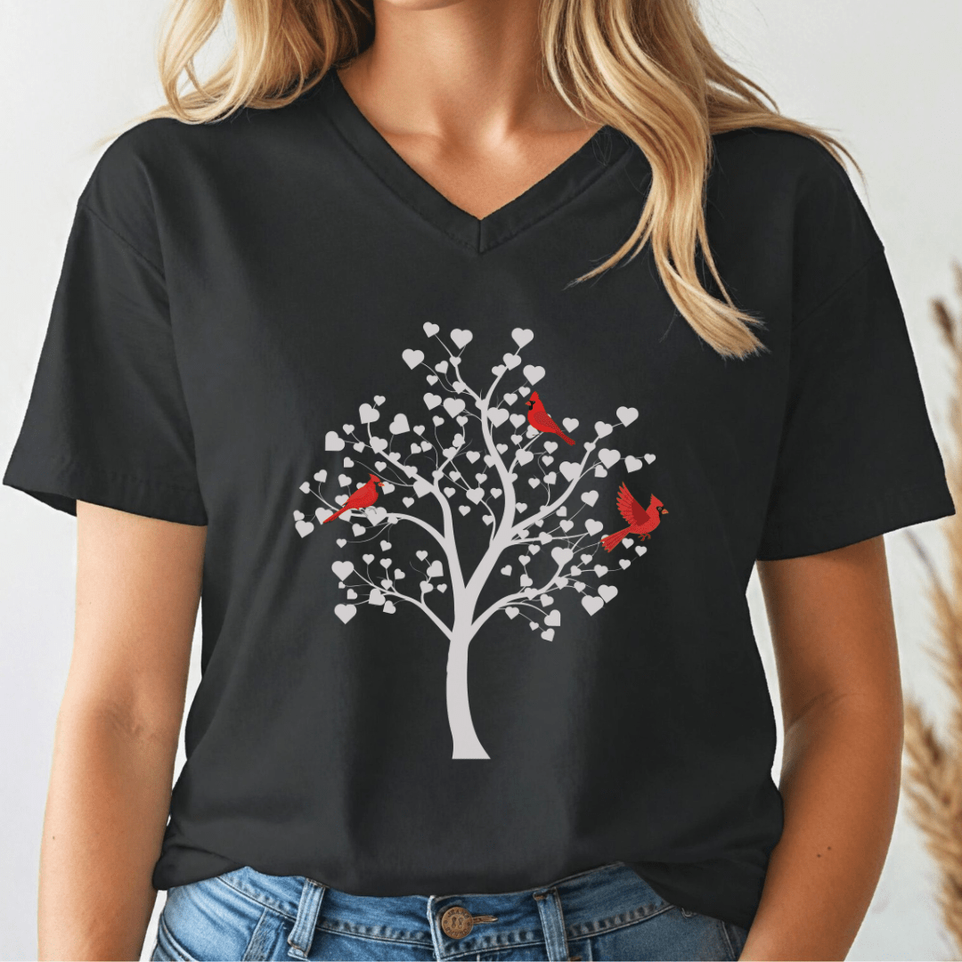 Black v-neck t-shirt with a white tree and cardinals design worn by a person.
