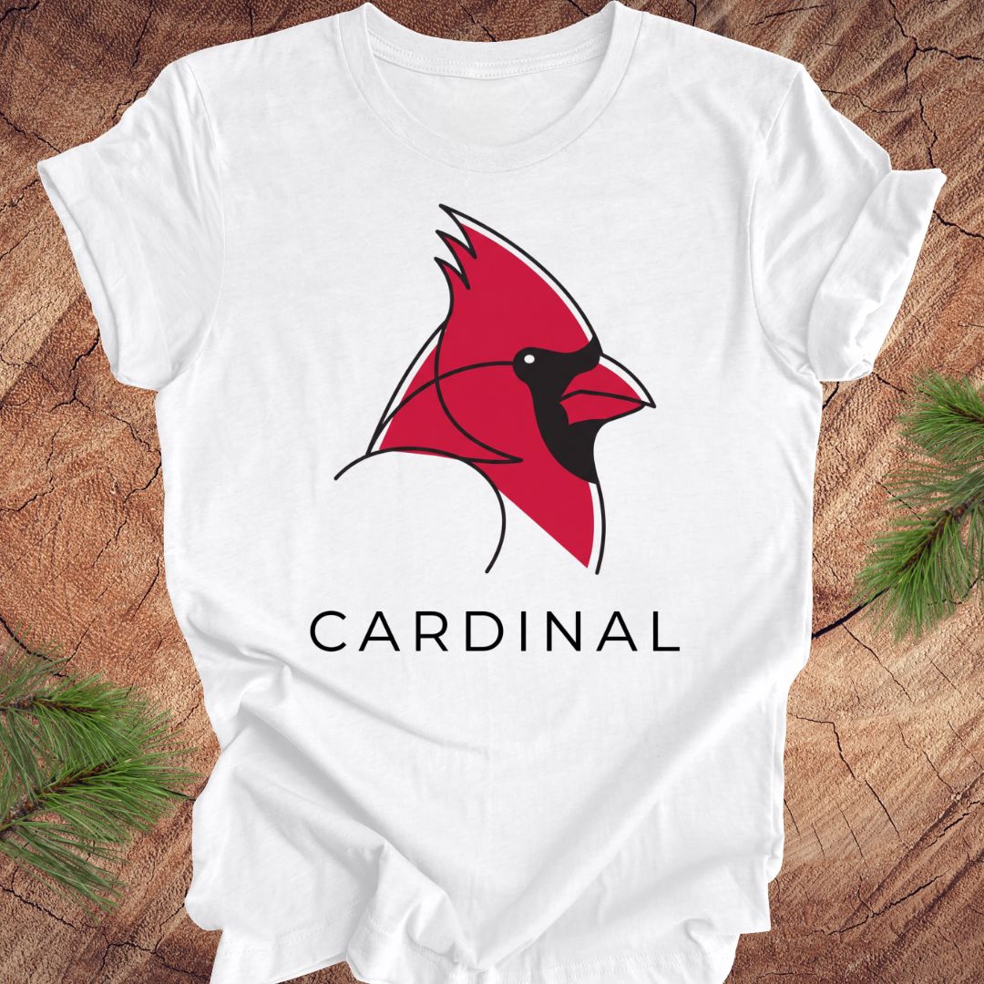 White t-shirt with a cardinal and text on a wood background.