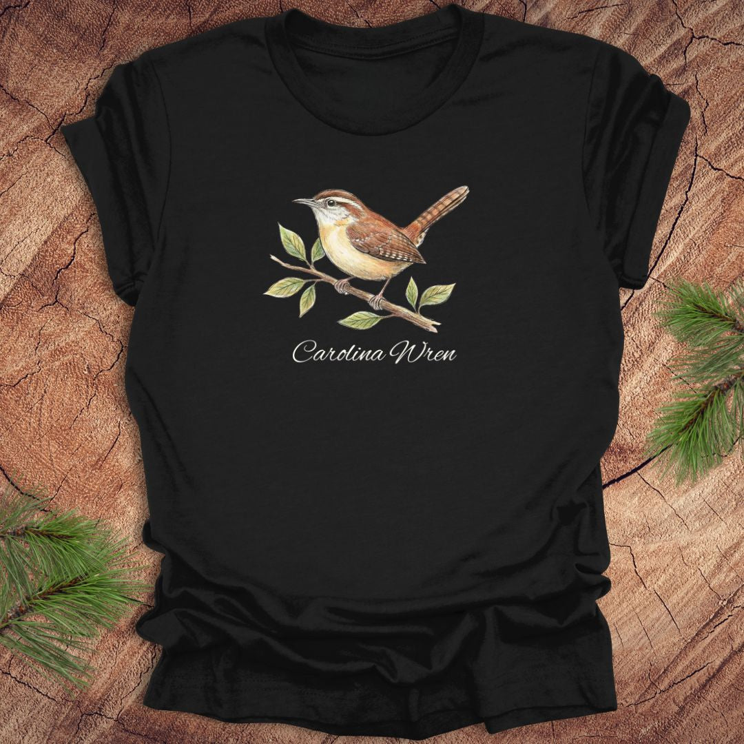 Black t-shirt with a Carolina Wren illustration and text, 'carolina wren' on a wooden surface