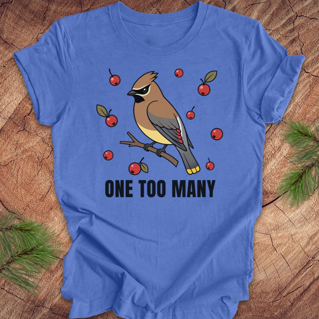 Blue t-shirt with a cedar waxwing bird and berry design on a wooden surface