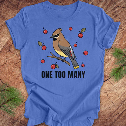 Blue t-shirt with a cedar waxwing bird and berry design on a wooden surface