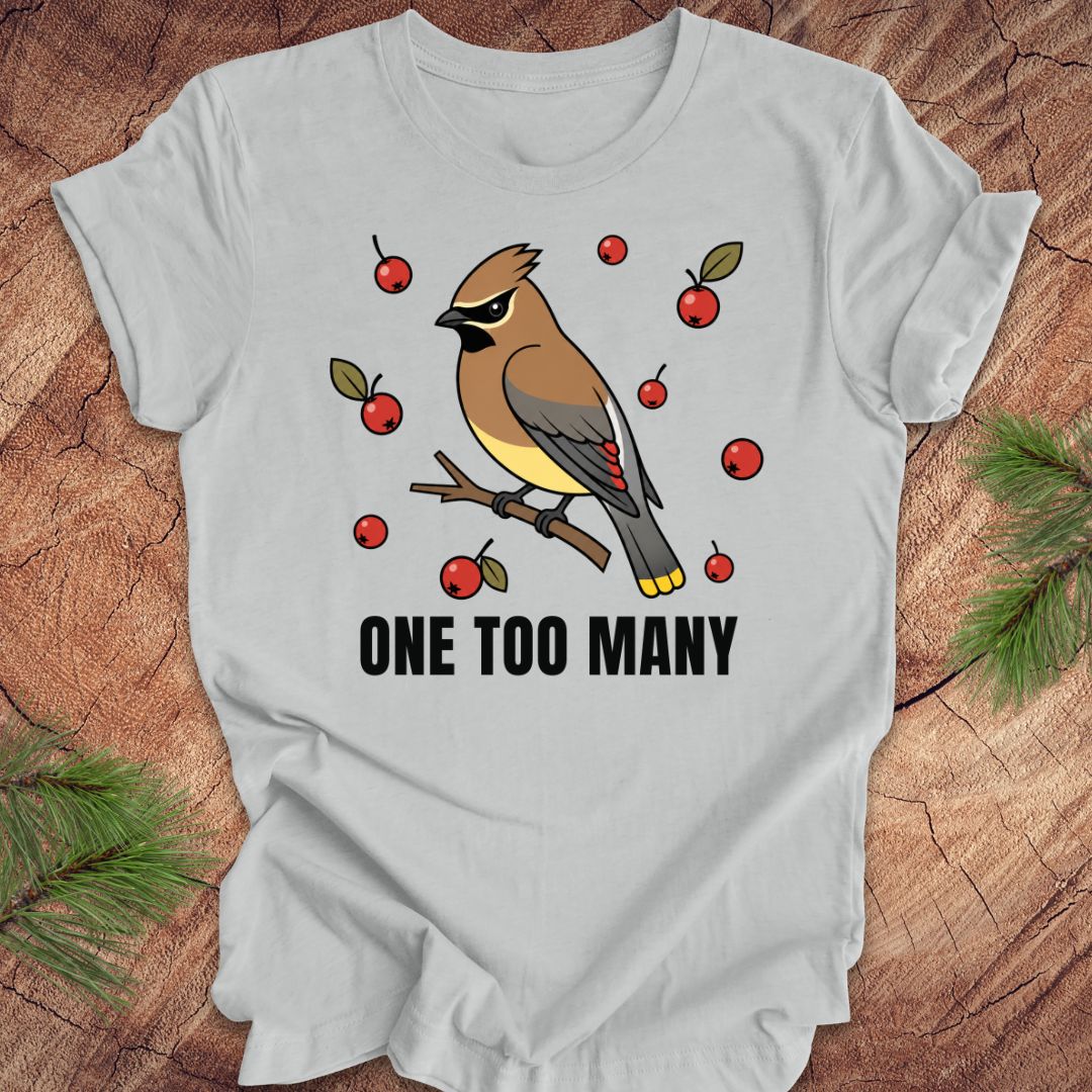 Gray t-shirt with a cedar waxwing bird and berry design on a wooden surface