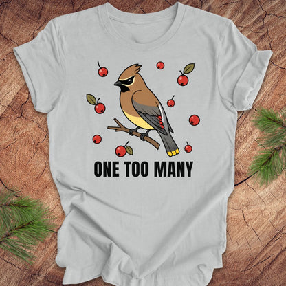 Gray t-shirt with a cedar waxwing bird and berry design on a wooden surface