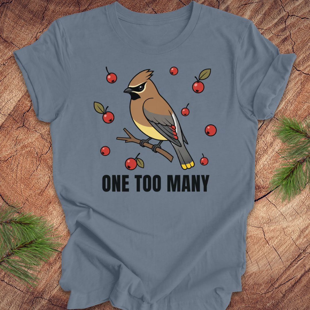 Blue t-shirt with a cedar waxwing bird and berry design on a wooden surface
