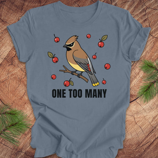 Blue t-shirt with a cedar waxwing bird and berry design on a wooden surface