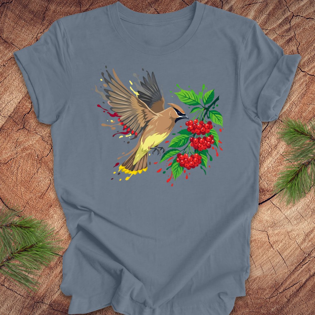 Blue t-shirt with a cedar waxwing bird and berry design on a wooden surface