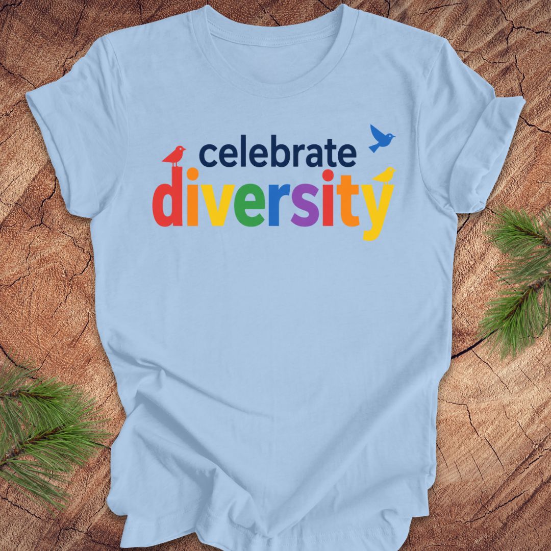 Light blue t-shirt with 'celebrate diversity' text on a wooden surface