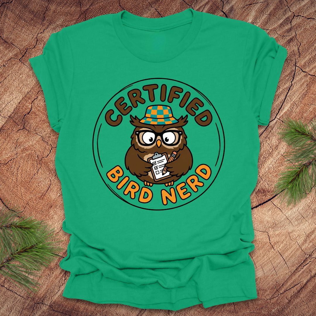 Green t-shirt with owl graphic and 'Certified Bird Nerd' text on a wooden surface.