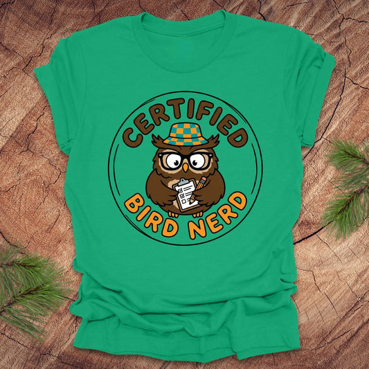 Green t-shirt with owl graphic and 'Certified Bird Nerd' text on a wooden surface.