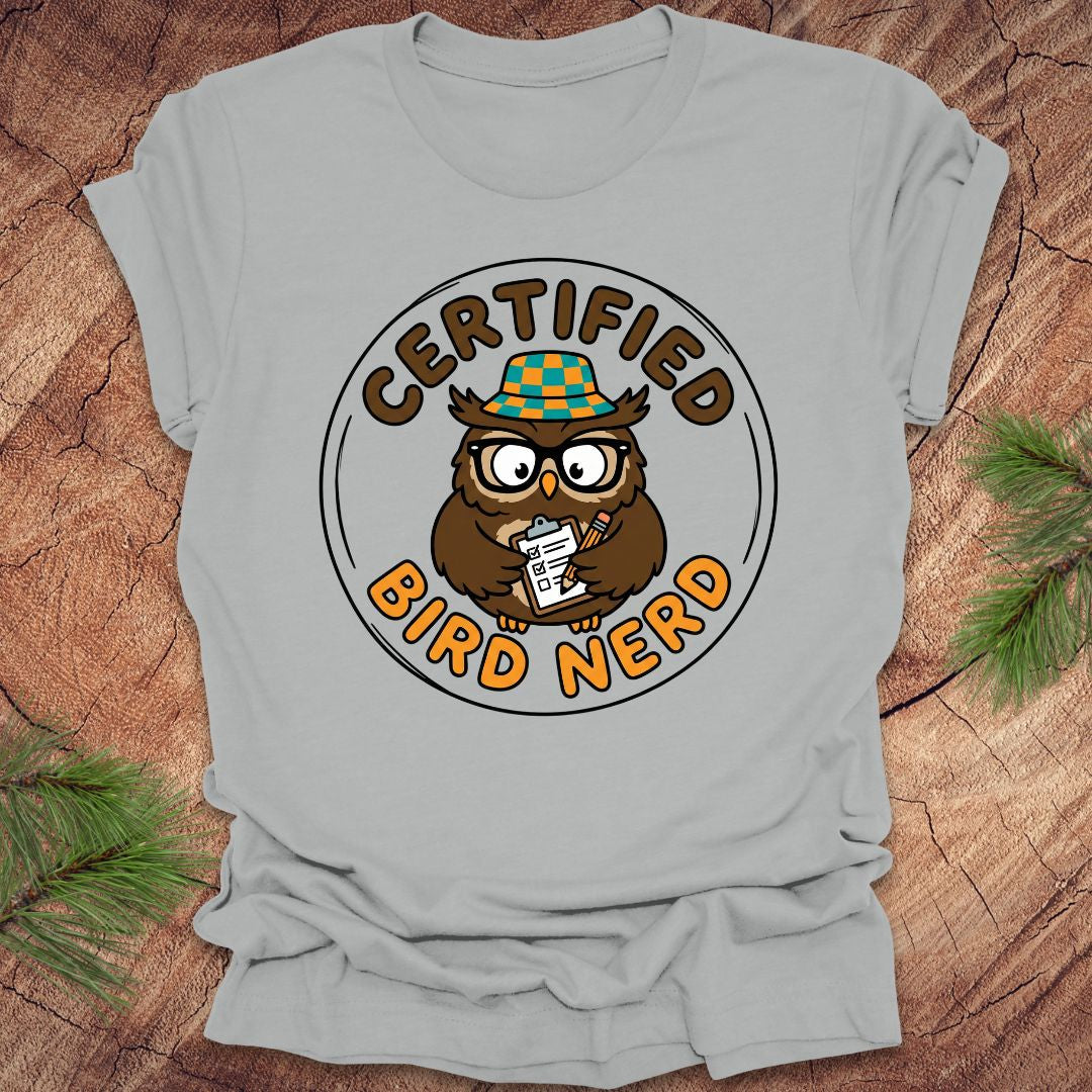 Gray t-shirt with an owl graphic and 'Certified Bird Nerd' text on a wooden surface.
