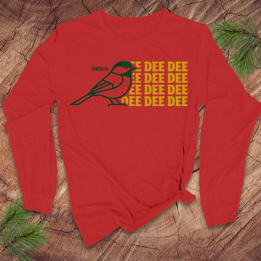 Red long-sleeve shirt with a chickadee graphic and 'DEE DEE DEE' text on a wooden surface.