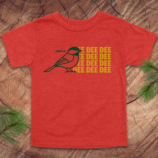 Red toddler tshirt with a chickadee design and text on a wood background.