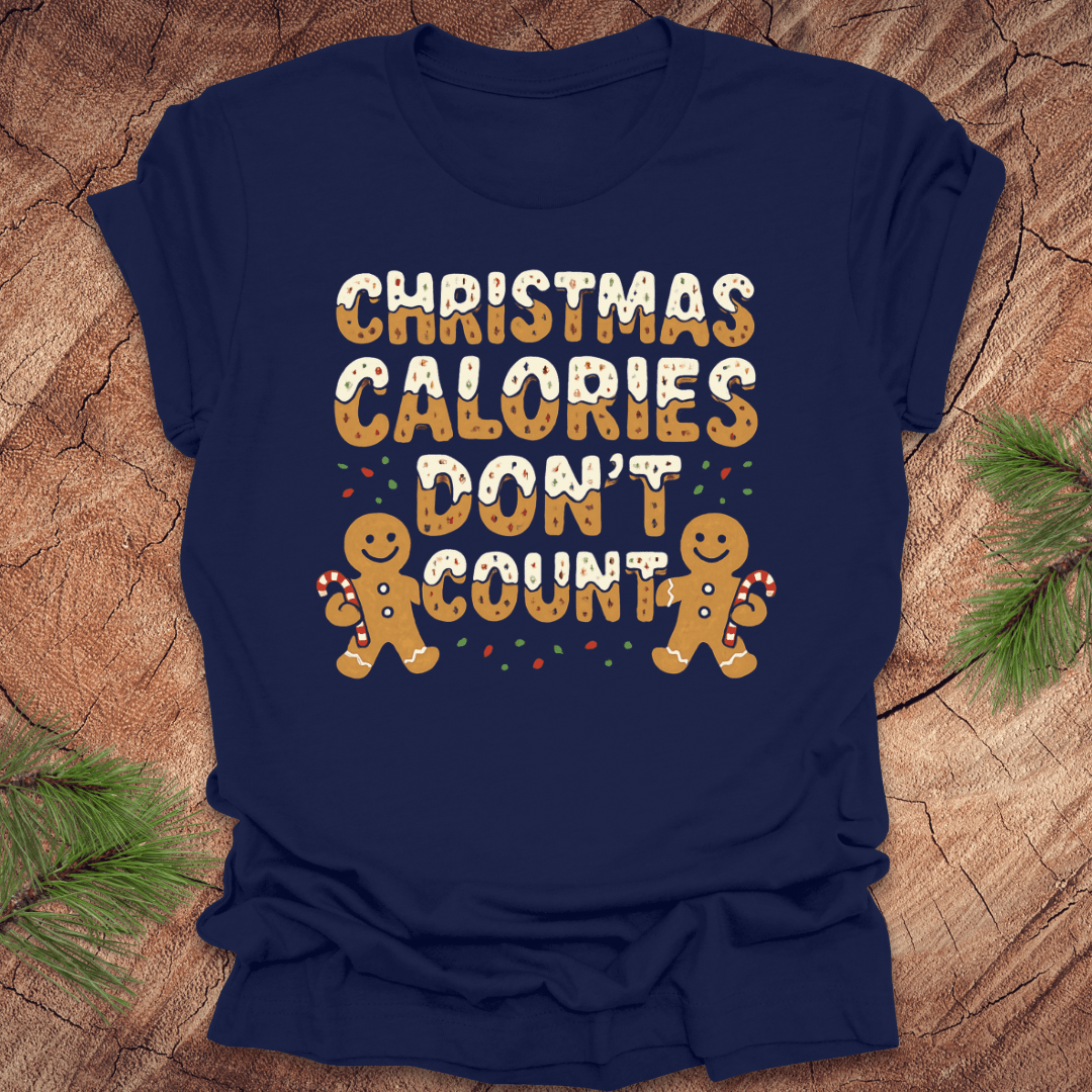 Navy tshirt with festive gingerbread text, 'Christmas calories don't count' with gingerbread men on a wooden background.