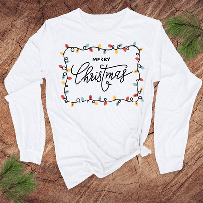 White long-sleeve shirt with 'Merry Christmas' design on a wooden surface