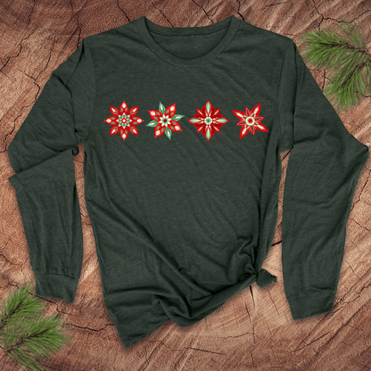 Green long-sleeve shirt with red poinsettia designs on a wooden surface