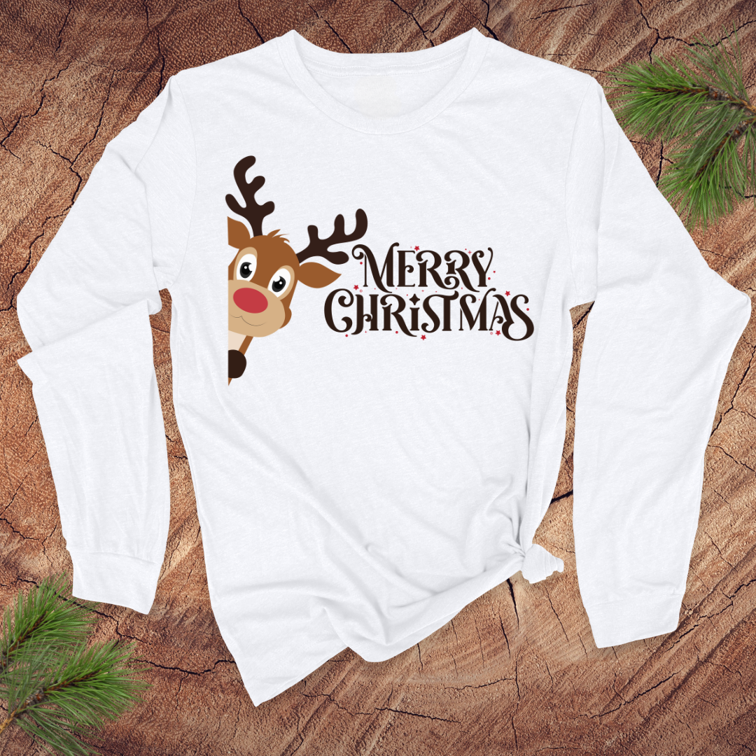 White long-sleeve shirt with a reindeer and 'Merry Christmas' text on a wooden surface.