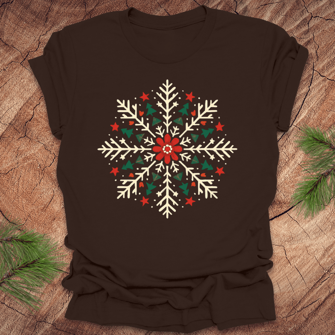 Brown t-shirt with a Christmas-themed snowflake design on a wooden surface.