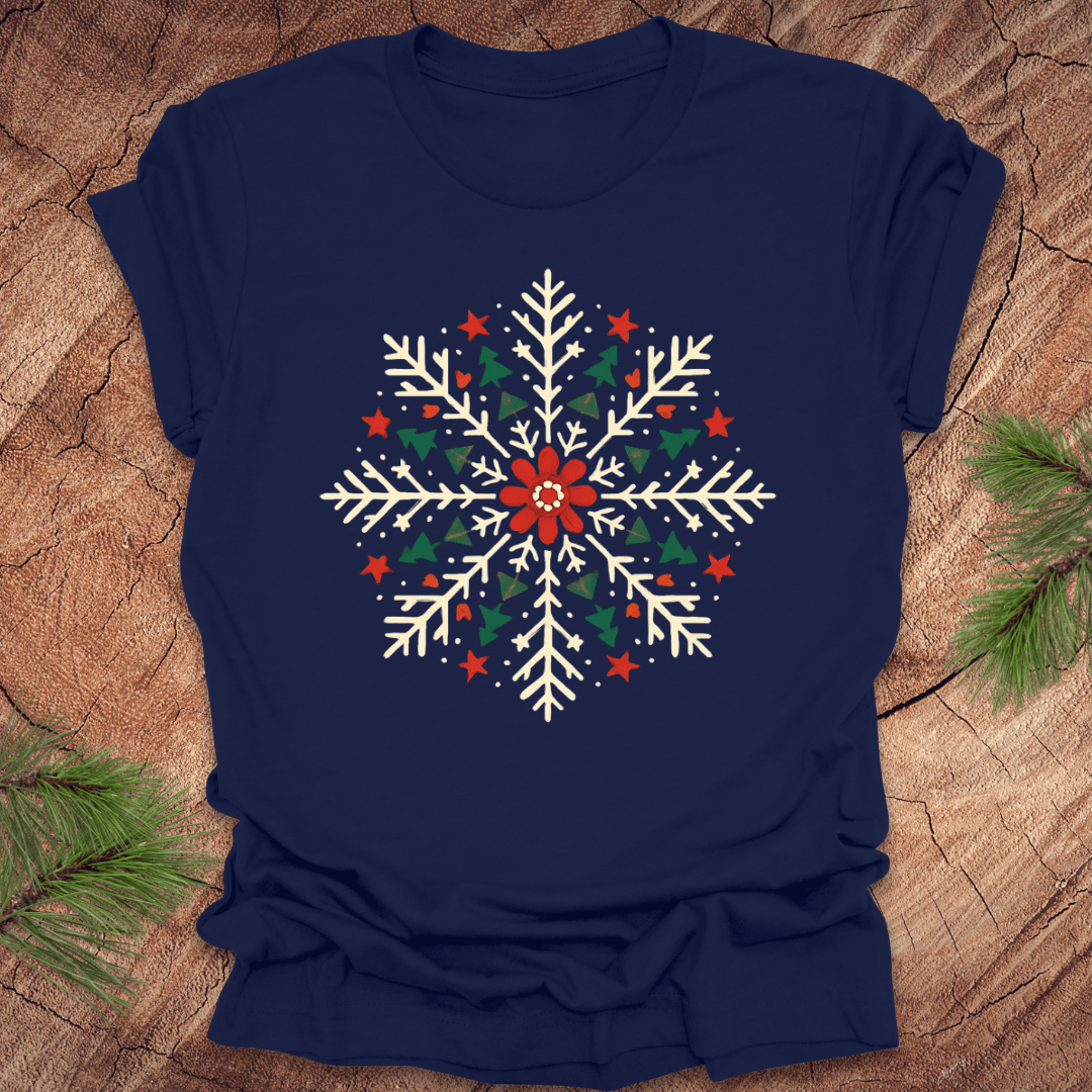 Navy blue t-shirt with a colorful snowflake design on a wooden surface.