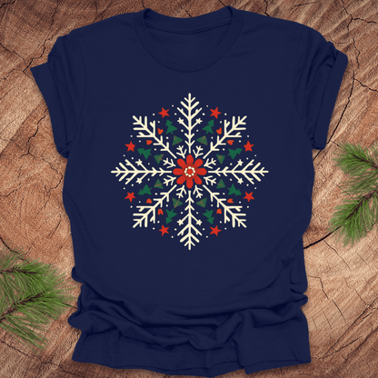 Navy blue t-shirt with a colorful snowflake design on a wooden surface.