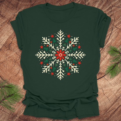Green t-shirt with a colorful snowflake design on a wooden surface