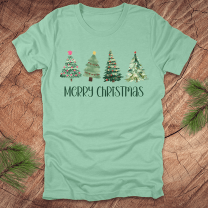 Mint green tshirt with the text 'Merry Christmas' and christmas trees on a wood background.