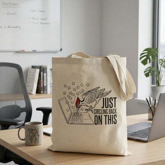 Tote bag with a woodpecker design and text 'just circling back on this' in an office setting.