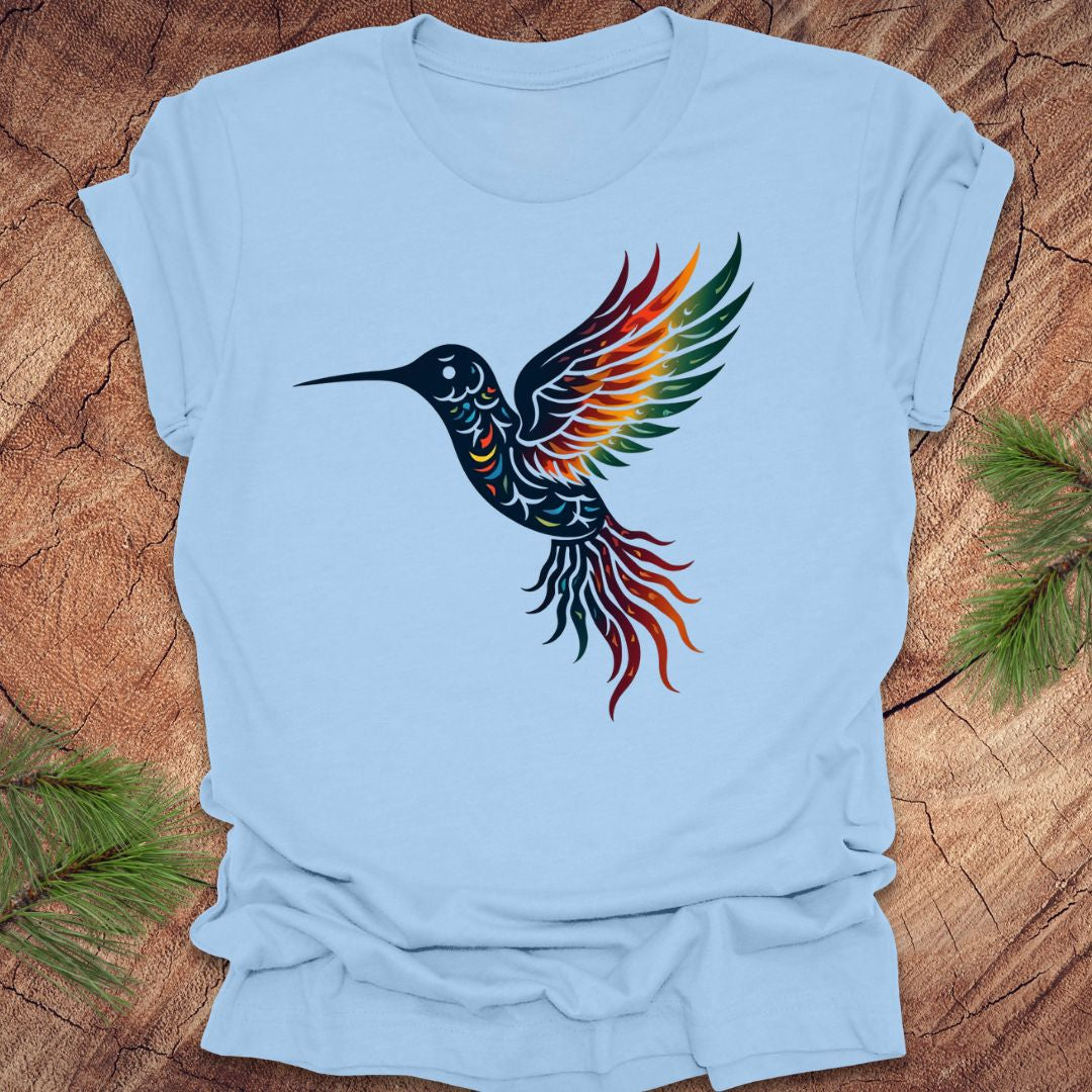 Baby blue tshirt with a colorful hummingbird design on a wood background