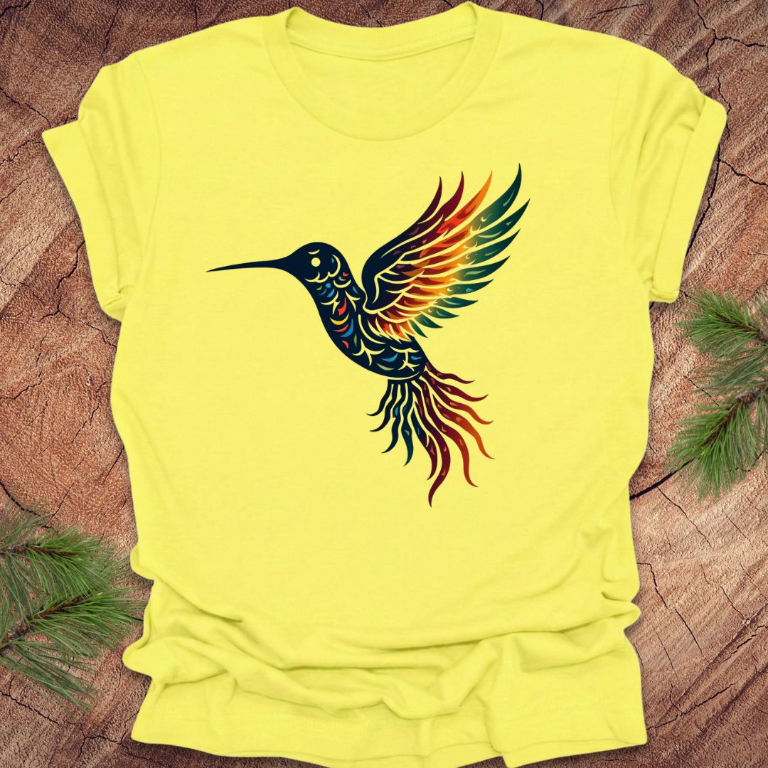 Yellow t-shirt with a colorful hummingbird design on a wooden surface.