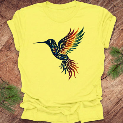 Yellow t-shirt with a colorful hummingbird design on a wooden surface.
