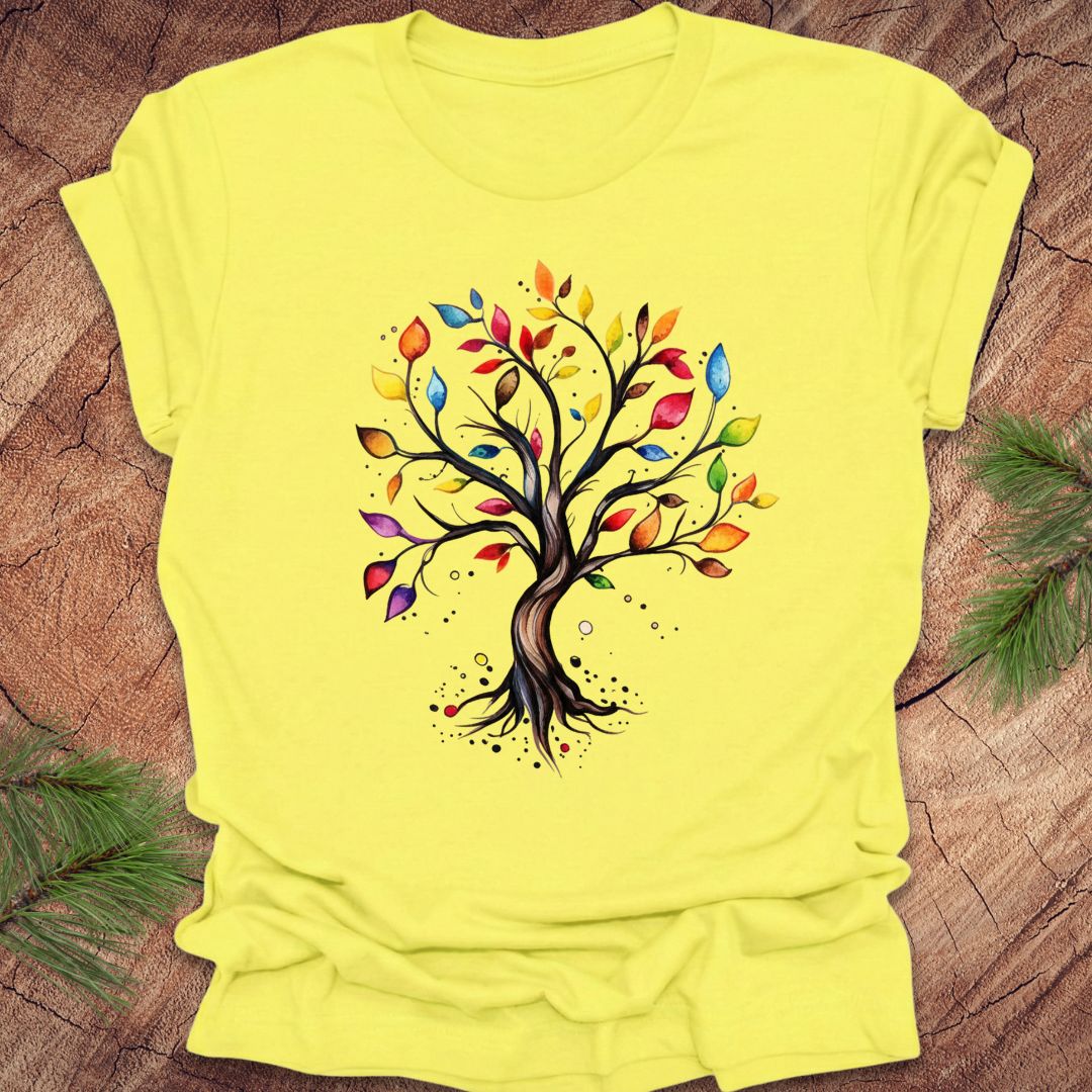 Yellow t-shirt with a colorful tree design on a wooden surface