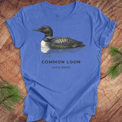Blue t-shirt with a common loon on a wood background.