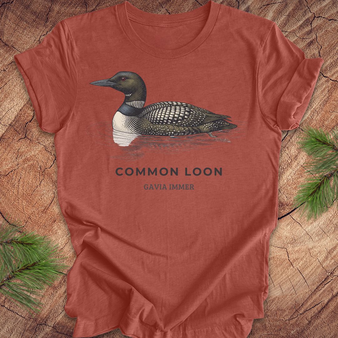 Clay colored t-shirt with a common loon on a wood background.
