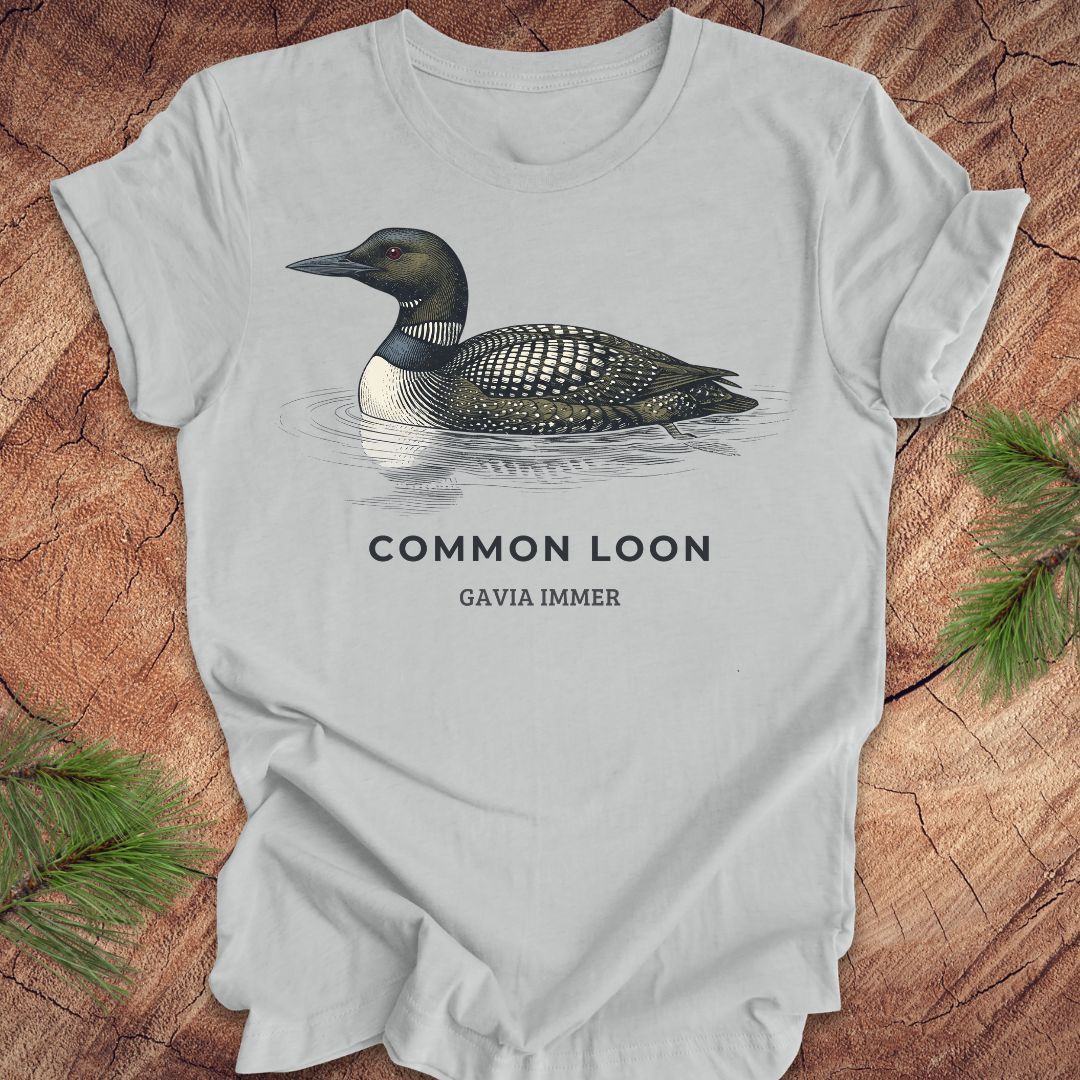 Gray t-shirt with a common loon on a wood background.