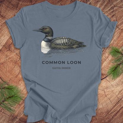 Blue t-shirt with a common loon on a wood background.