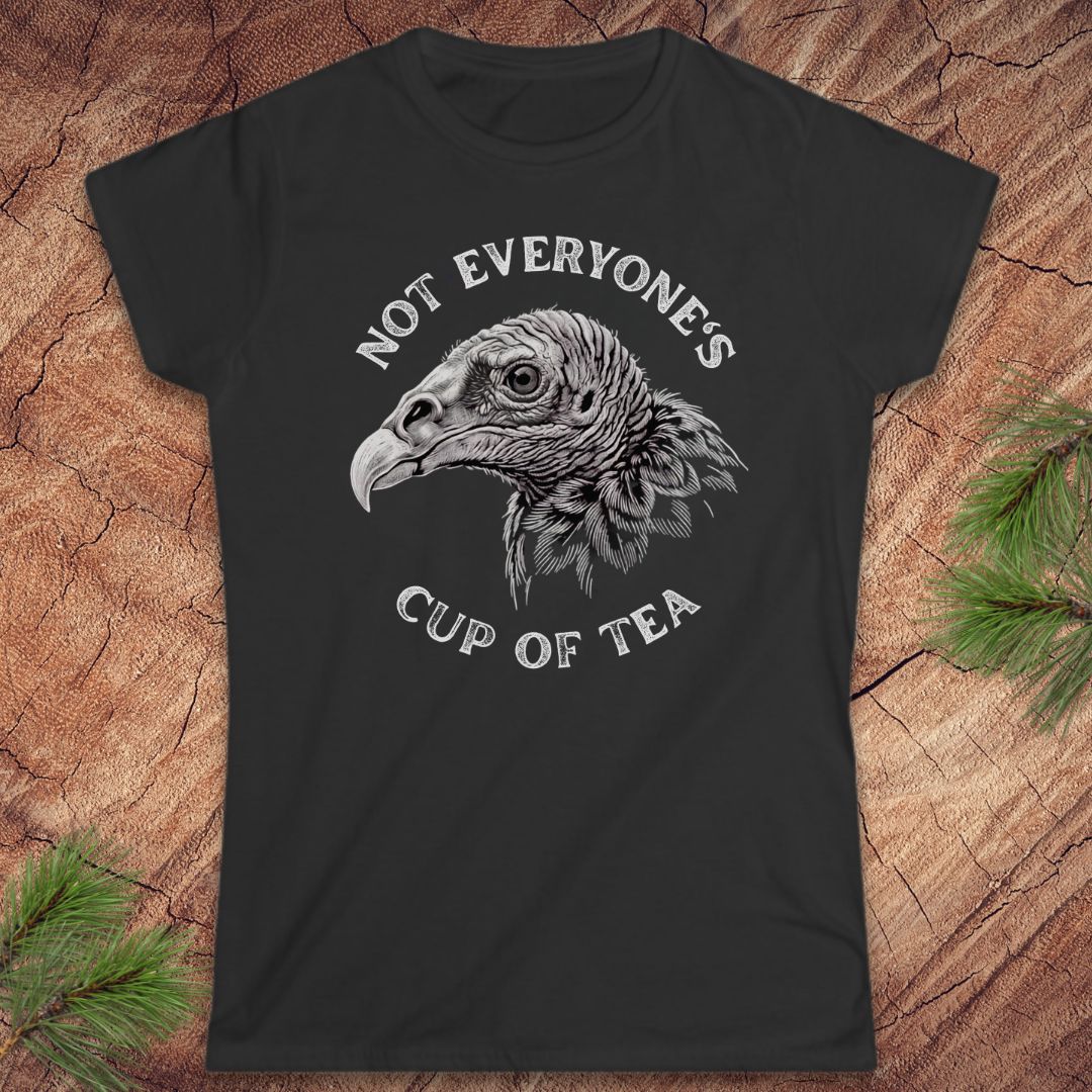 Black t-shirt with a vulture and text, 'not everyone's cup of tea' on a wood background.