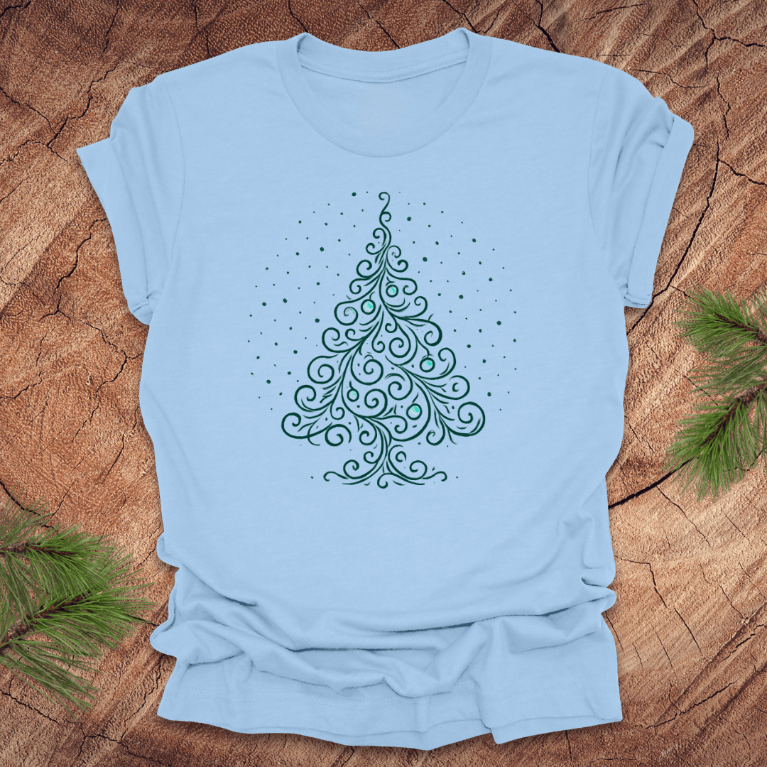 Light blue t-shirt with a decorative Christmas tree design on a wooden surface.