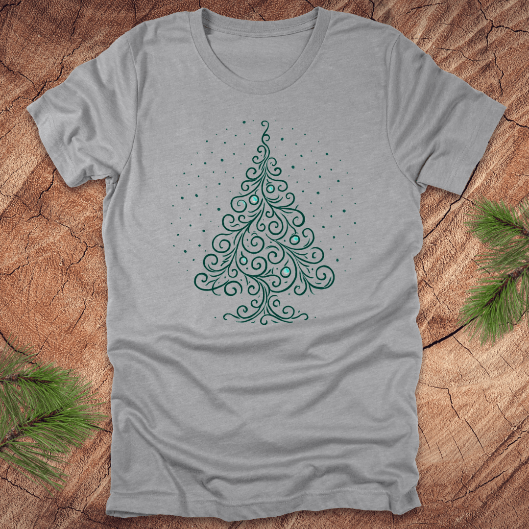 Gray t-shirt with a green Christmas tree design on a wooden surface