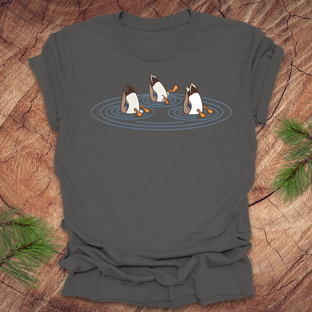 Gray t-shirt with cartoon ducks dabbling on a pond design on a wooden surface