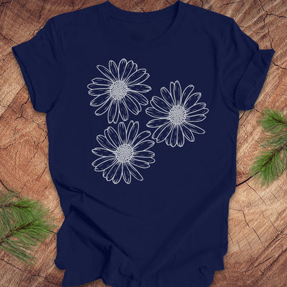 Navy blue t-shirt with daisy designs on a wooden surface