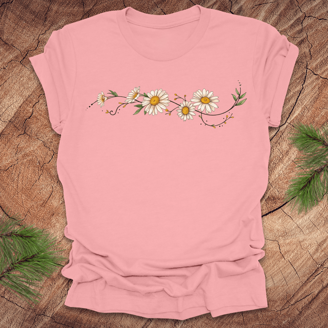 Pink t-shirt with daisy design on a wooden surface