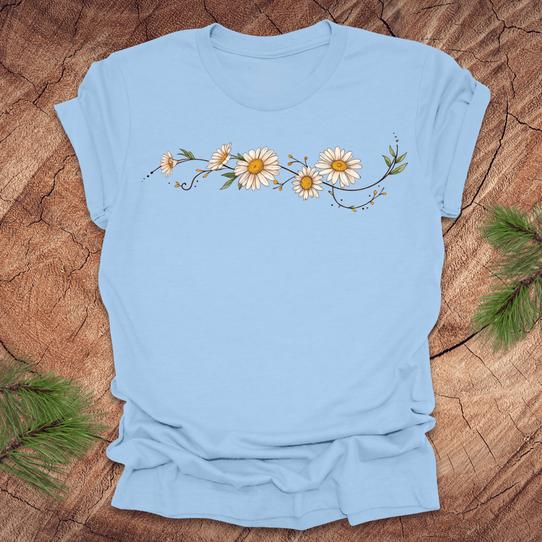Baby blue t-shirt with daisy design on a wooden surface