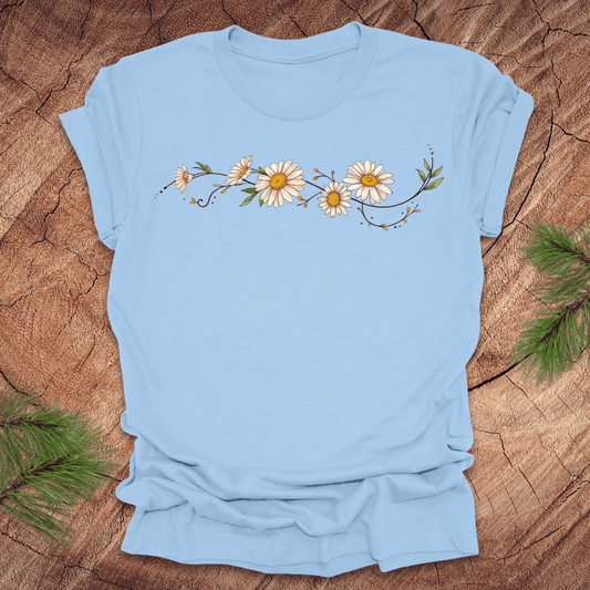 Baby blue t-shirt with daisy design on a wooden surface