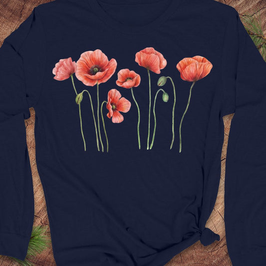 A navy blue long-sleeve t-shirt with a watercolor-style print of five red poppy flowers with green stems, laid flat on a rustic wood background.