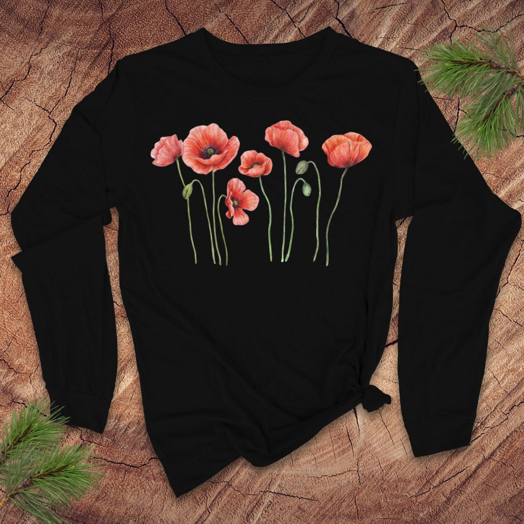 Black long-sleeve tshirt with pink poppies design on a wooden surface