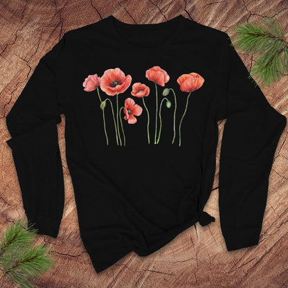 Black long-sleeve tshirt with pink poppies design on a wooden surface