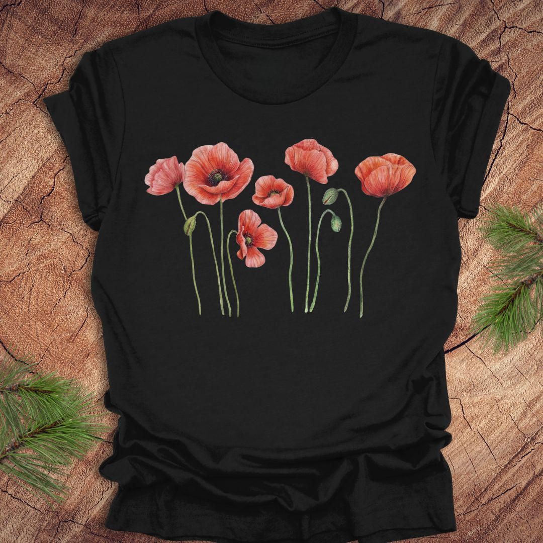 Black t-shirt with pink floral design on a wooden surface