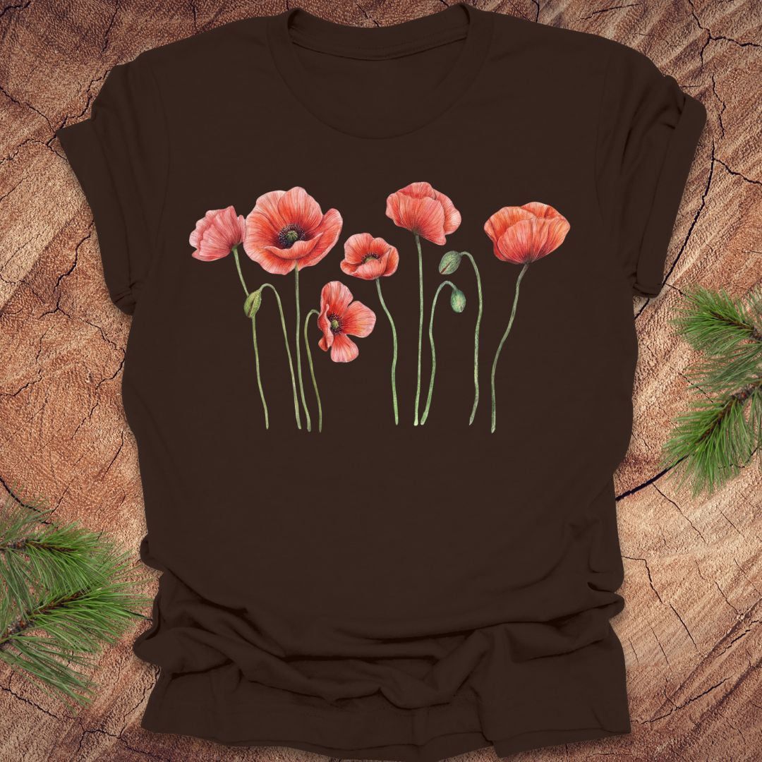 Brown t-shirt with red poppy flower design on a wooden surface