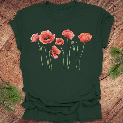 Green t-shirt with red floral design on a wooden surface